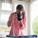 Women taking photos at set for creative marketing agency in Costa Mesa